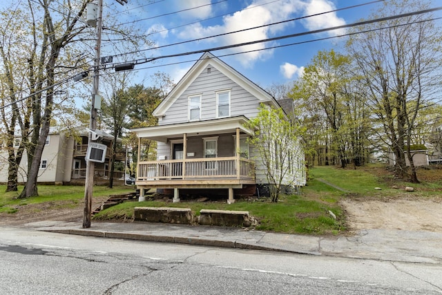 shotgun-style home featuring covered porch