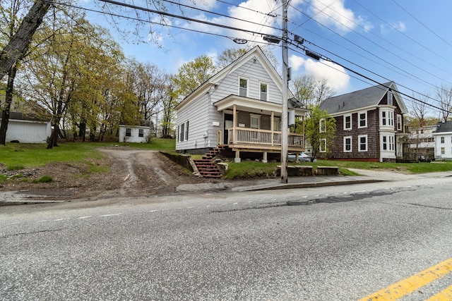 shotgun-style home with a porch and stairs