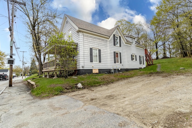 view of property exterior with roof with shingles