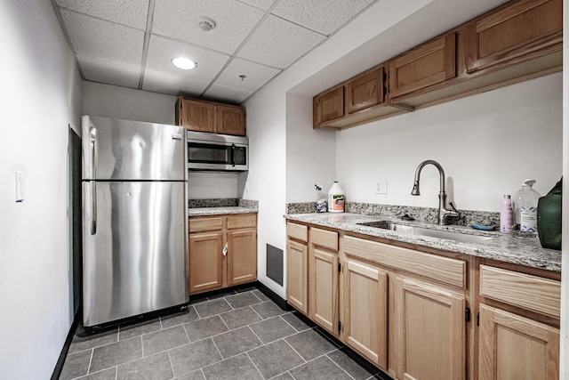 79 Bramhall St, Portland, ME 04102 - kitchen featuring stainless steel appliances, a sink, light stone countertops, recessed lighting, and a paneled ceiling