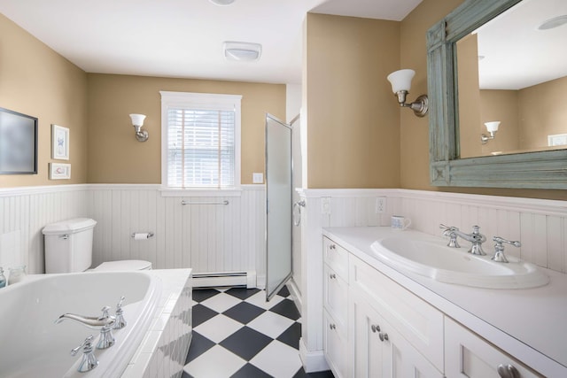 150 Webhannet Dr, Wells, ME 04090 - full bath featuring a wainscoted wall, tile patterned floors, toilet, a garden tub, and vanity