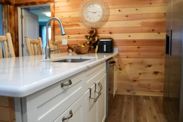 50 Beans Mill Rd, Corinth, ME 04427 - kitchen featuring a sink, wooden walls, dark wood finished floors, white cabinetry, and light stone counters