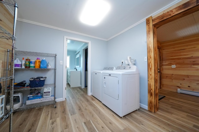 50 Beans Mill Rd, Corinth, ME 04427 - clothes washing area with washing machine and dryer, ornamental molding, light wood-type flooring, a baseboard heating unit, and baseboards