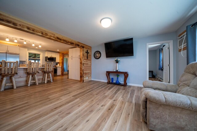 50 Beans Mill Rd, Corinth, ME 04427 - living room featuring light wood-type flooring, baseboards, rail lighting, and a baseboard radiator