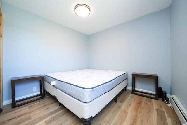 50 Beans Mill Rd, Corinth, ME 04427 - bedroom with a baseboard heating unit, wood finished floors, and baseboards