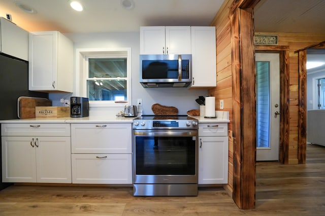50 Beans Mill Rd, Corinth, ME 04427 - kitchen with appliances with stainless steel finishes, white cabinetry, light countertops, light wood-style flooring, and recessed lighting