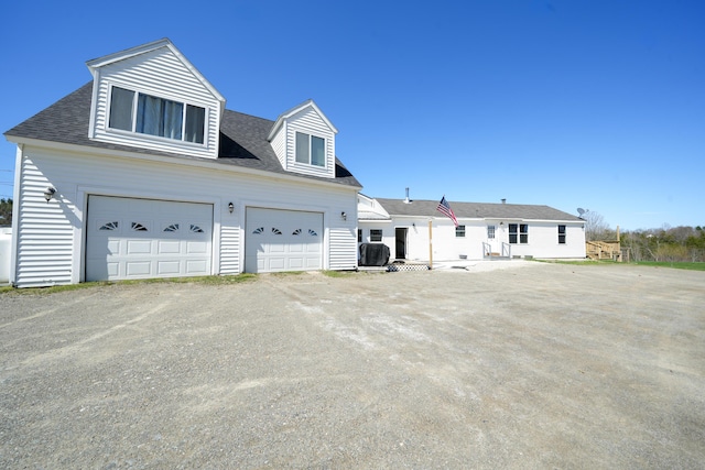 50 Beans Mill Rd, Corinth, ME 04427 - view of front facade featuring a garage, roof with shingles, and driveway