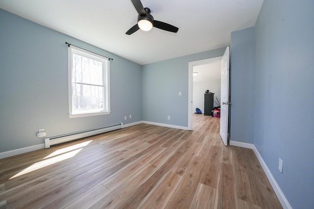 50 Beans Mill Rd, Corinth, ME 04427 - unfurnished bedroom featuring a baseboard heating unit, light wood-style flooring, baseboards, and a ceiling fan
