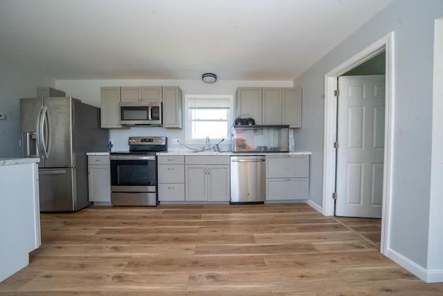 50 Beans Mill Rd, Corinth, ME 04427 - kitchen featuring stainless steel appliances, a sink, light wood finished floors, and gray cabinets