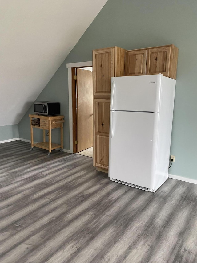 50 Beans Mill Rd, Corinth, ME 04427 - kitchen with freestanding refrigerator, lofted ceiling, dark wood-style floors, and stainless steel microwave