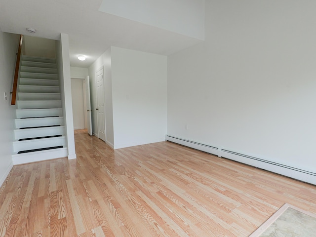 35 Mathews Ave Unit 8, Waterville, ME 04901 - empty room with light wood-type flooring, stairs, a baseboard heating unit, a smoke detector, and baseboards