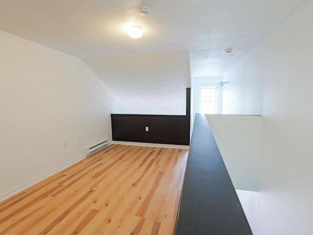 35 Mathews Ave Unit 8, Waterville, ME 04901 - empty room featuring baseboard heating, wood finished floors, a textured ceiling, a smoke detector, and baseboards