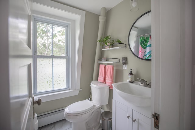 bathroom with toilet, vanity, and a baseboard radiator