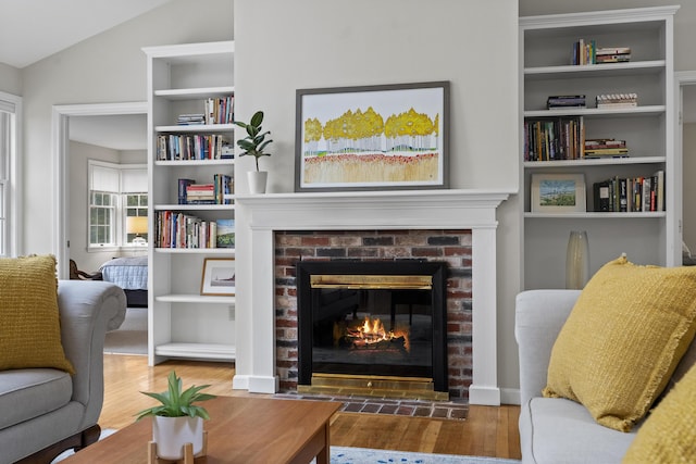 49 Dipper Cove Rd, Harpswell, ME 04066 - living room with wood finished floors, a fireplace, vaulted ceiling, and built in features