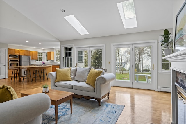 49 Dipper Cove Rd, Harpswell, ME 04066 - living area with a baseboard heating unit, a skylight, light wood finished floors, plenty of natural light, and recessed lighting