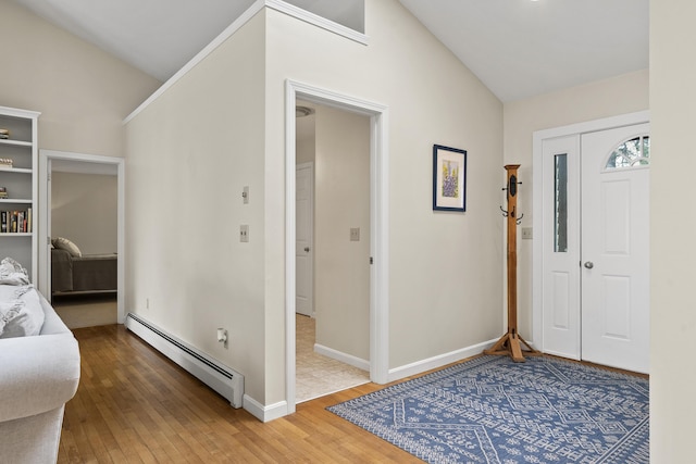 49 Dipper Cove Rd, Harpswell, ME 04066 - foyer entrance with a baseboard heating unit, lofted ceiling, and light wood-style flooring