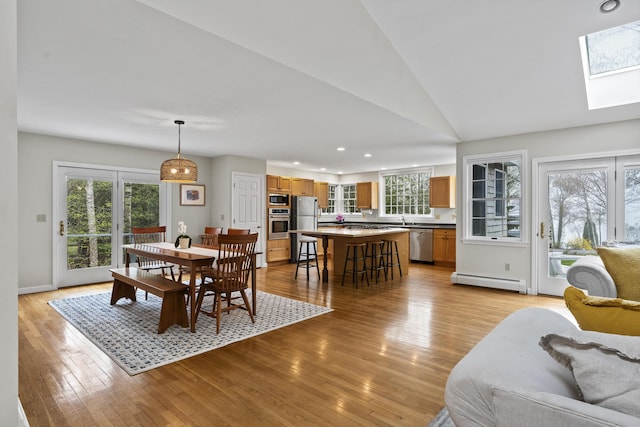 49 Dipper Cove Rd, Harpswell, ME 04066 - dining room featuring a baseboard heating unit, a skylight, light wood finished floors, plenty of natural light, and recessed lighting