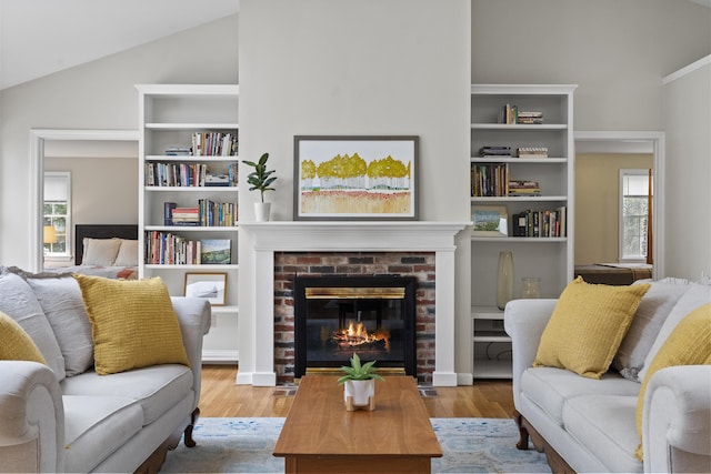 49 Dipper Cove Rd, Harpswell, ME 04066 - living area featuring lofted ceiling, wood finished floors, and a brick fireplace