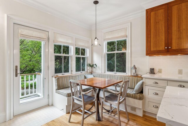 31 Mackworth St, Portland, ME 04103 - dining room featuring breakfast area, healthy amount of natural light, crown molding, and light wood-style flooring