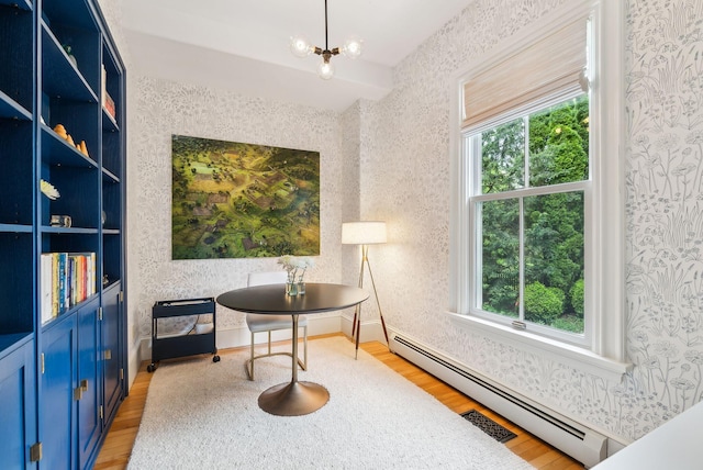31 Mackworth St, Portland, ME 04103 - living area featuring wallpapered walls, light wood finished floors, a baseboard radiator, and healthy amount of natural light