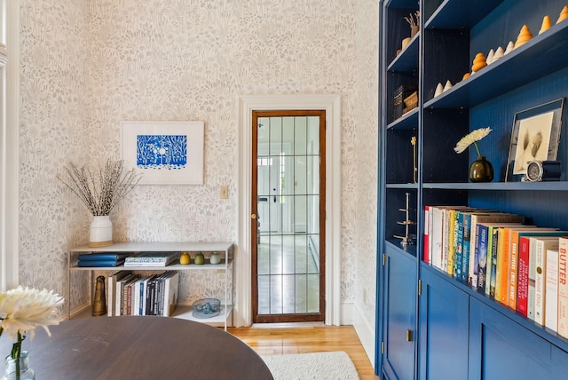 31 Mackworth St, Portland, ME 04103 - sitting room with wallpapered walls, light wood-style floors, and baseboards