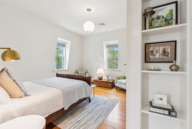 31 Mackworth St, Portland, ME 04103 - bedroom with multiple windows, wood finished floors, and a baseboard heating unit