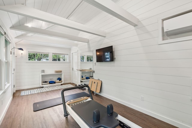 31 Mackworth St, Portland, ME 04103 - exercise room featuring baseboards, wood walls, wood finished floors, and a wall mounted air conditioner
