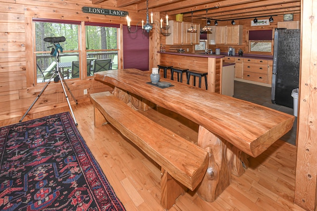 dining room featuring hardwood / wood-style floors and wood walls