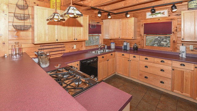 kitchen featuring a sink, dishwasher, light brown cabinetry, healthy amount of natural light, and wood walls