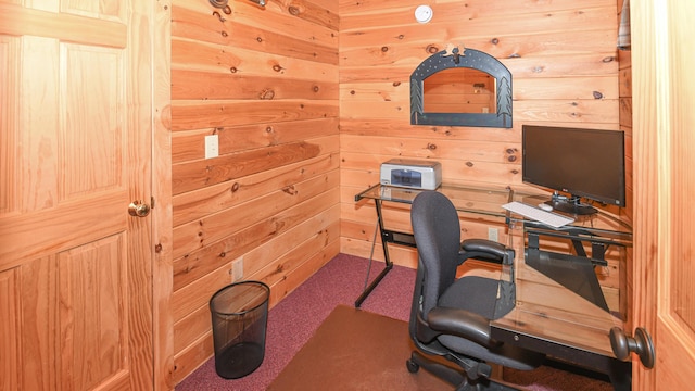 carpeted home office with wooden walls