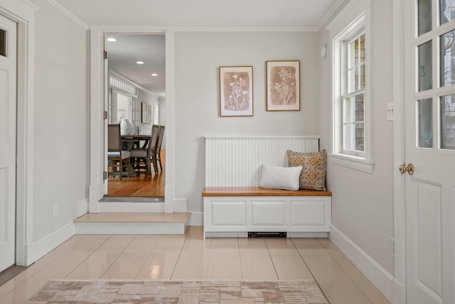 hall featuring plenty of natural light, light tile patterned flooring, crown molding, baseboards, and recessed lighting