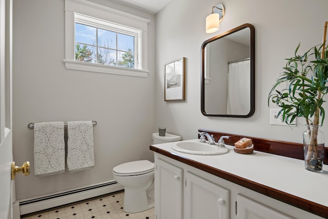 bathroom featuring a baseboard radiator, vanity, toilet, and tile patterned floors