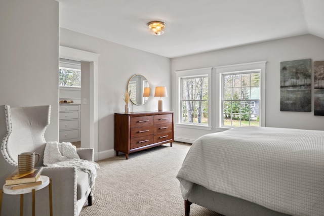 bedroom with light carpet, baseboards, vaulted ceiling, and baseboard heating