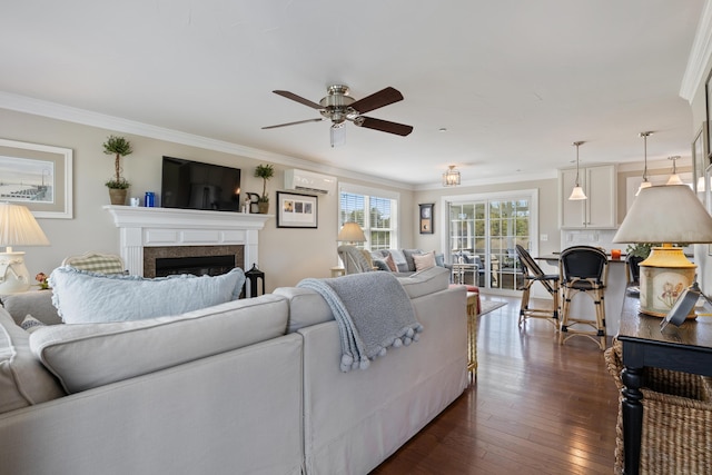 42 Snowberry Dr, Gorham, ME 04038 - living area with a wall mounted AC, ceiling fan, crown molding, a fireplace, and dark wood-style flooring