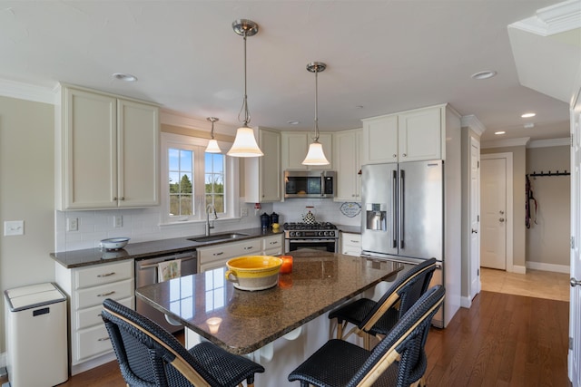 42 Snowberry Dr, Gorham, ME 04038 - kitchen featuring appliances with stainless steel finishes, a sink, backsplash, baseboards, and crown molding