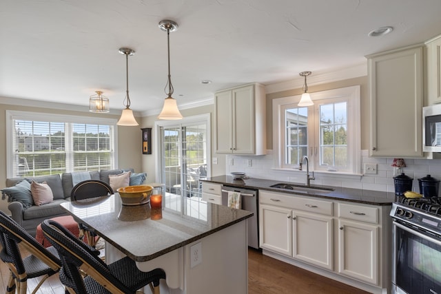 42 Snowberry Dr, Gorham, ME 04038 - kitchen with stainless steel appliances, a sink, tasteful backsplash, crown molding, and hanging light fixtures
