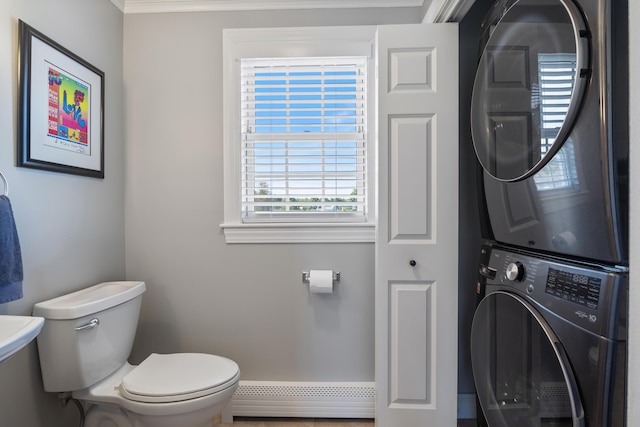 42 Snowberry Dr, Gorham, ME 04038 - bathroom with stacked washing machine and dryer, a baseboard heating unit, and toilet