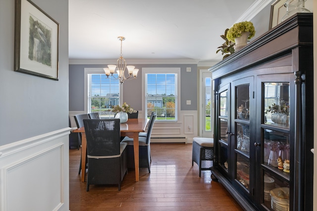 42 Snowberry Dr, Gorham, ME 04038 - dining area with a chandelier, baseboard heating, a decorative wall, a wainscoted wall, and ornamental molding