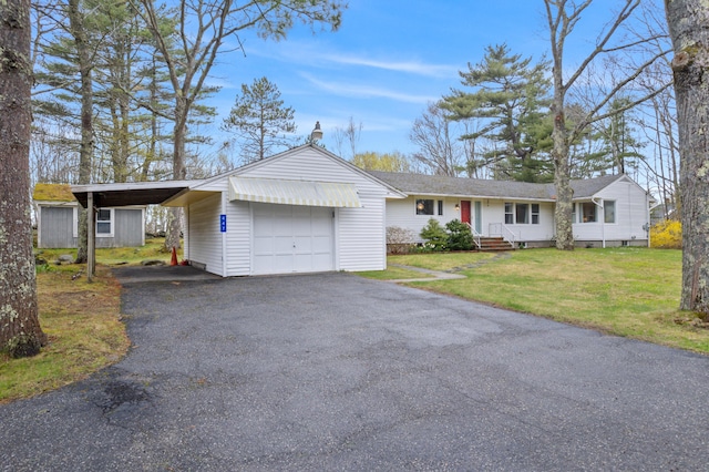 447 Wiscasset Rd, Boothbay, ME 04537 - ranch-style house with driveway, a front lawn, and an attached garage