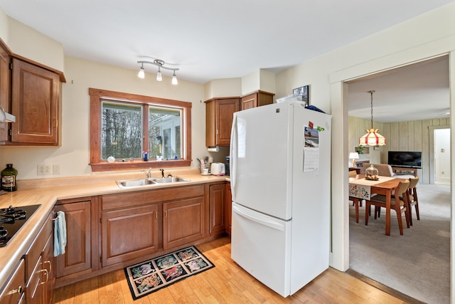 447 Wiscasset Rd, Boothbay, ME 04537 - kitchen with freestanding refrigerator, a sink, light countertops, and brown cabinets
