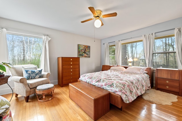 447 Wiscasset Rd, Boothbay, ME 04537 - bedroom featuring light wood-style flooring, multiple windows, a ceiling fan, and baseboards