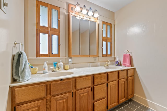 447 Wiscasset Rd, Boothbay, ME 04537 - bathroom with tile patterned floors, double vanity, and baseboards