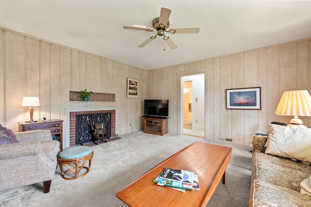 447 Wiscasset Rd, Boothbay, ME 04537 - living area with carpet floors, ceiling fan, a fireplace, and wooden walls