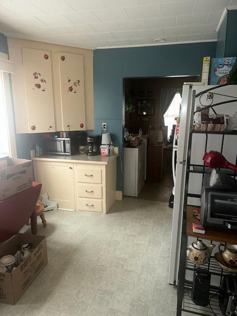627 Prospect Ave, Rumford, ME 04276 - kitchen featuring light countertops, white cabinetry, and light floors