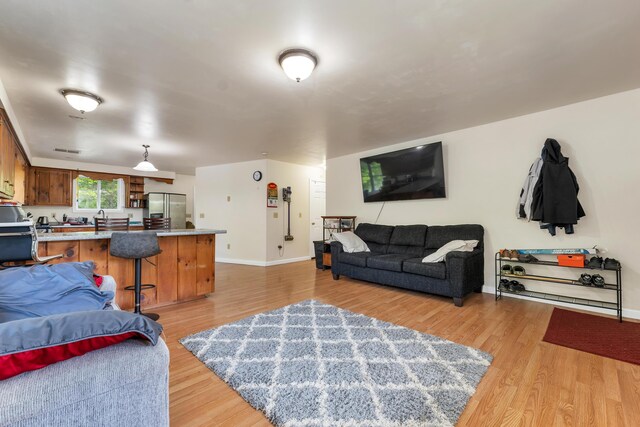 28-30 W Winds Dr, Lebanon, ME 04027 - living area with light wood-style flooring and baseboards