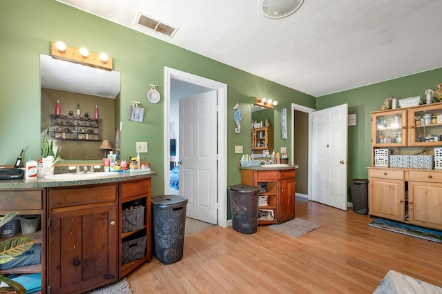 28-30 W Winds Dr, Lebanon, ME 04027 - bathroom with wood finished floors and vanity