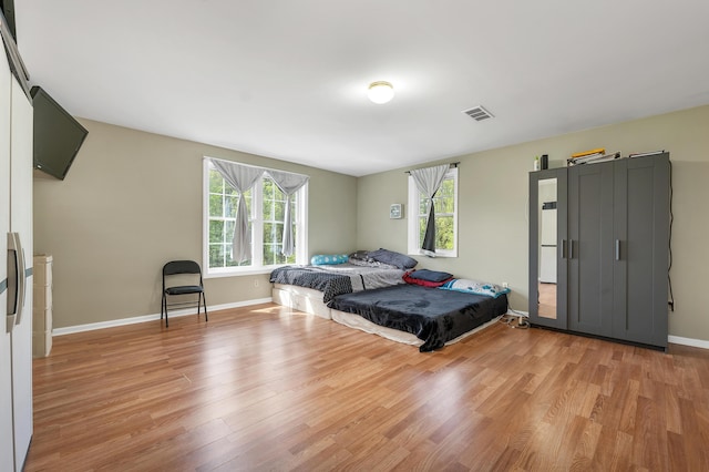 28-30 W Winds Dr, Lebanon, ME 04027 - bedroom featuring multiple windows, light wood-type flooring, and baseboards
