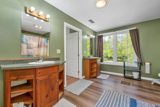 28-30 W Winds Dr, Lebanon, ME 04027 - bathroom featuring vanity, wood finished floors, baseboards, and curtained shower