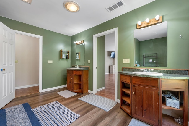 28-30 W Winds Dr, Lebanon, ME 04027 - full bath with two vanities, wood finished floors, and baseboards