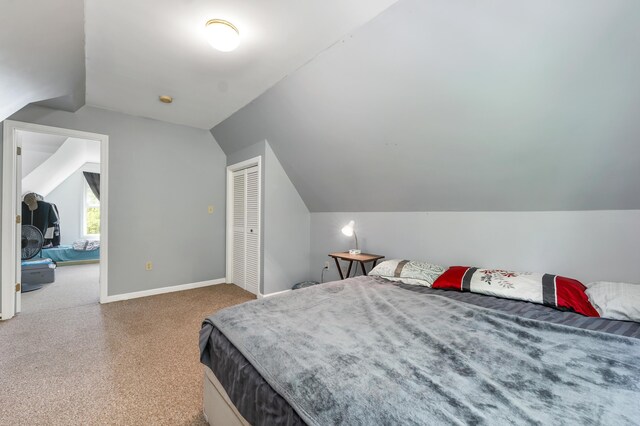 28-30 W Winds Dr, Lebanon, ME 04027 - carpeted bedroom with vaulted ceiling, baseboards, and a closet